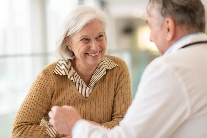 A woman discusses her health with her doctor.