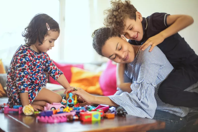 A mom playing with her kids.