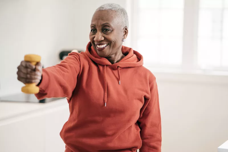 A mature woman exercising at home.
