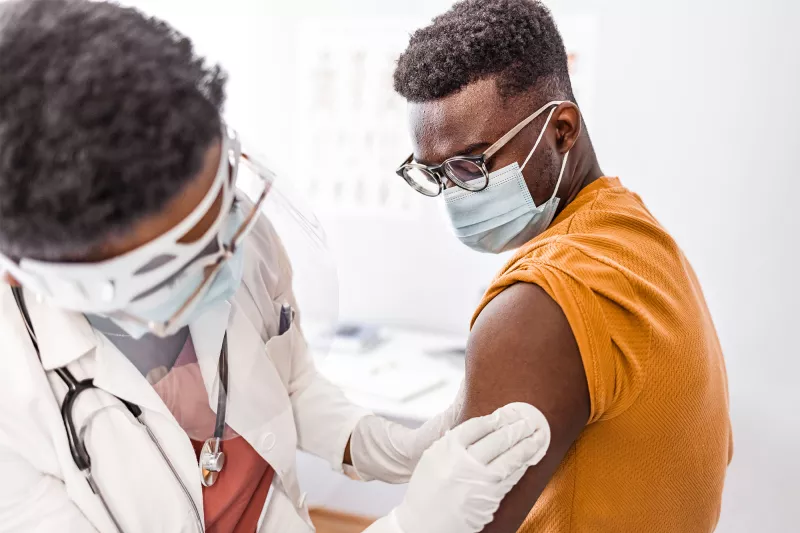 A patient getting cleaned up after a shot