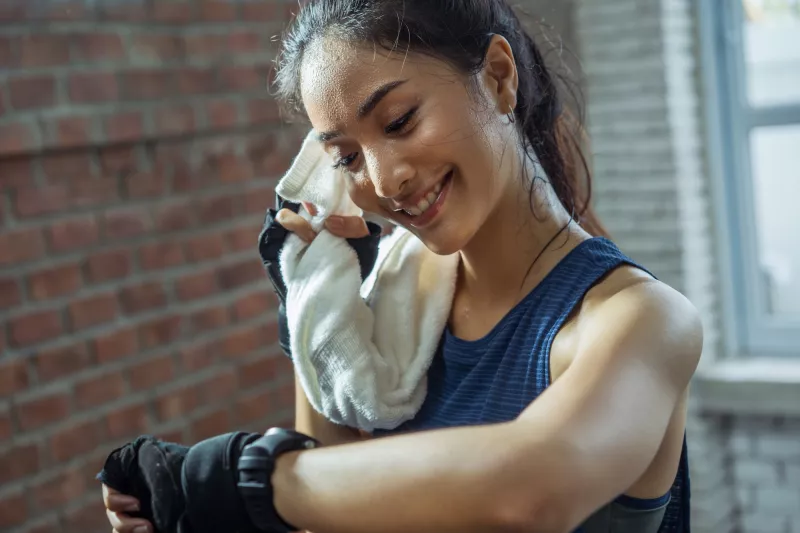 A runner takes a break to check her heart rate.