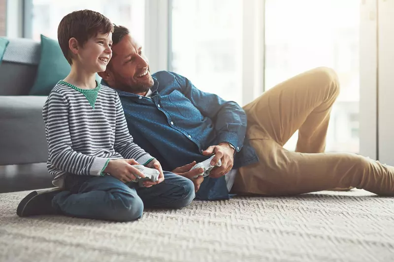 A father and son playing video games.