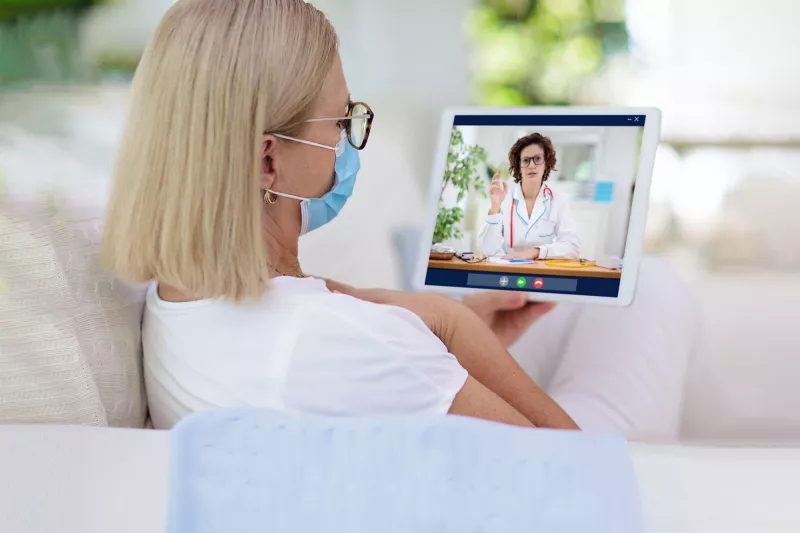 A woman visiting with a virtual doctor.