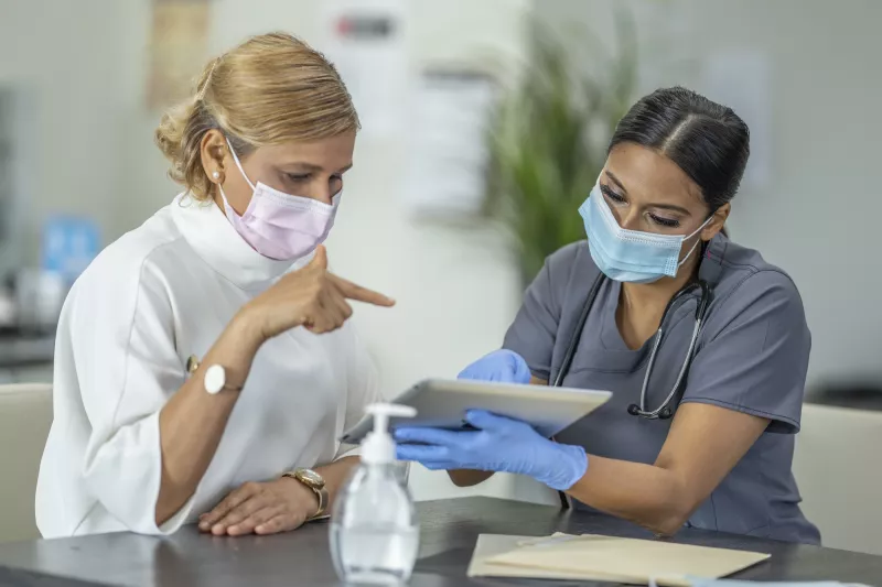 A woman discussing her health with her doctor.