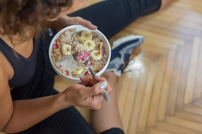A woman eating a healthy breakfast.