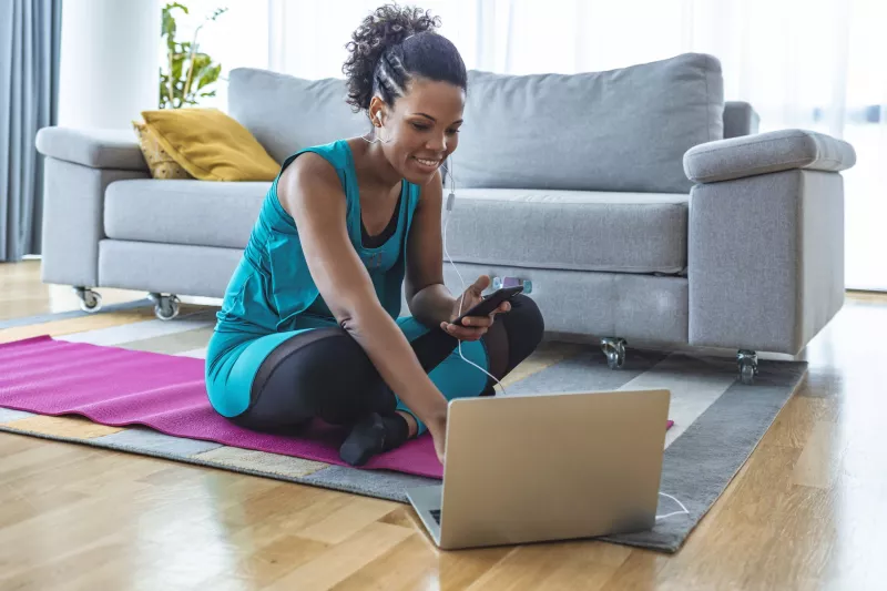 A woman preparing to exercise in her living room.