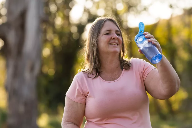 Overweight woman exercising outside