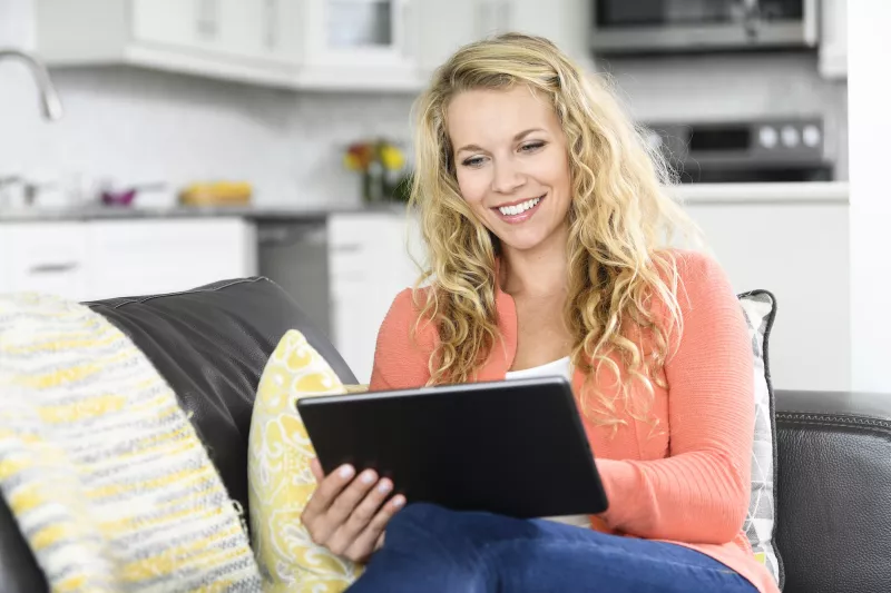 A woman reading on her tablet.