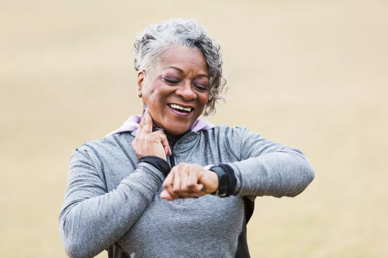 Female runner checking her wearable device