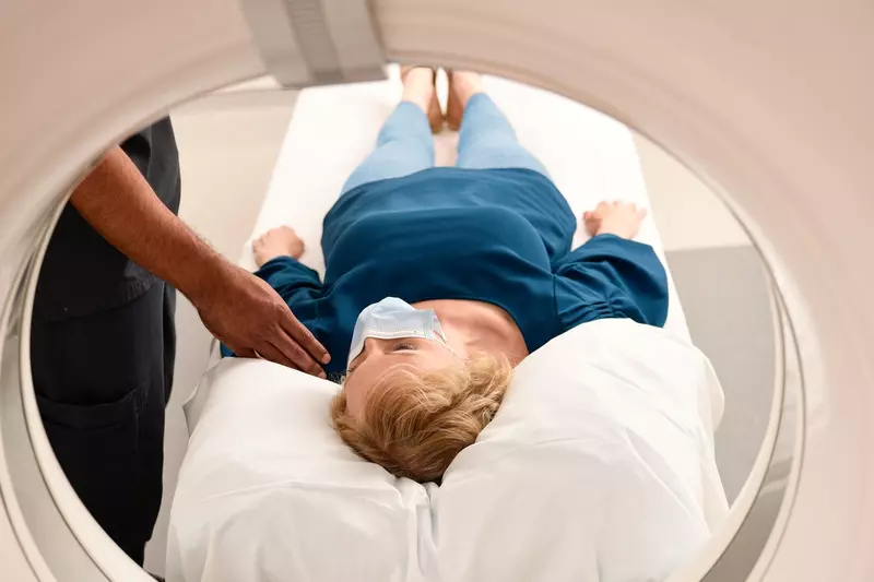 Woman wearing a mask getting an MRI