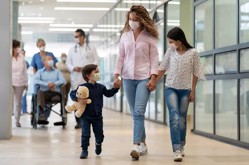 Mother, son and daughter leaving the emergency room.
