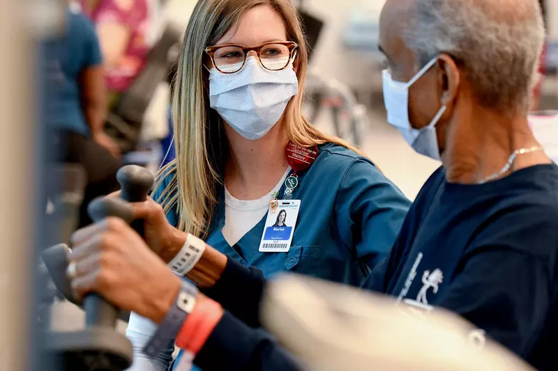 A nurse works with an older patient.