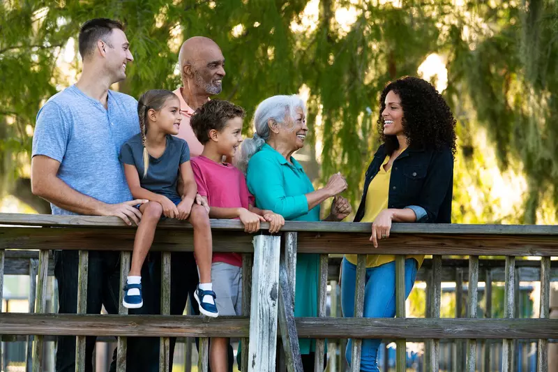 A Hispanic Family Chats on a Bridge in a Park