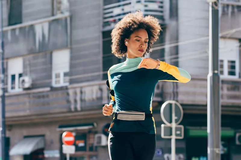 Young black woman running outside
