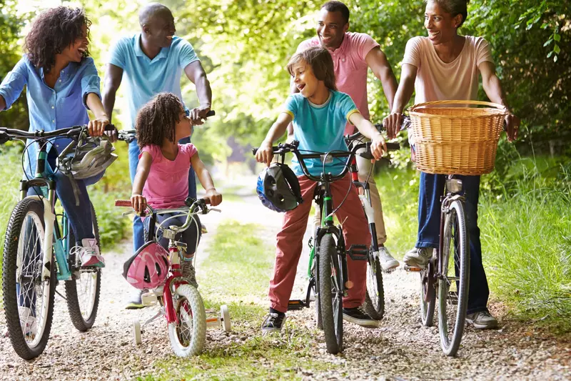 Multigenerational family riding bikes together.