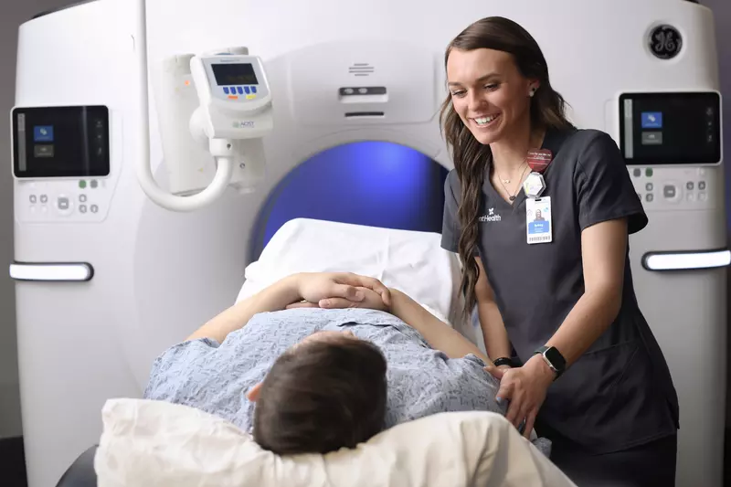 Radiologist reassures patient before imaging procedure.