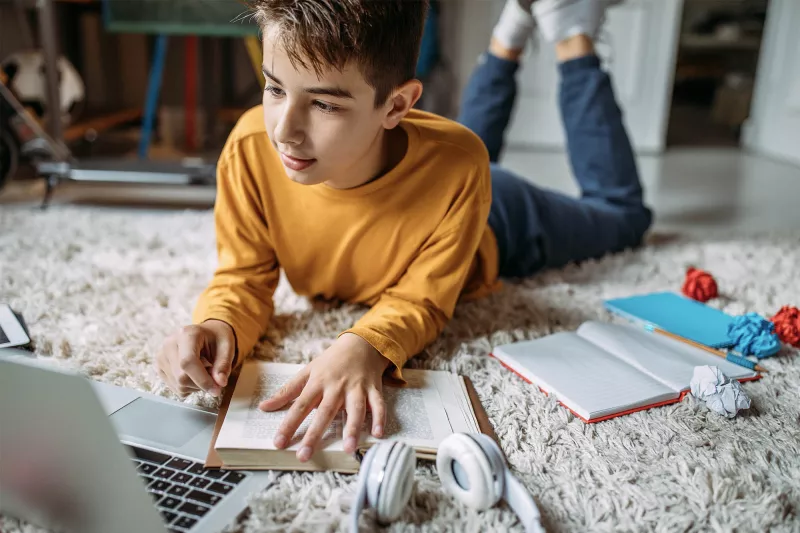 A teenage boy doing his homework.
