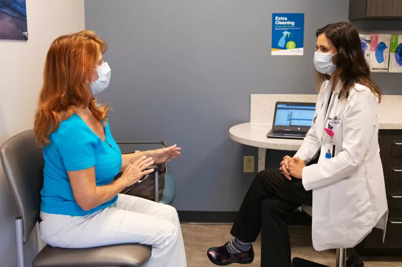 A patient discussing something to her doctor