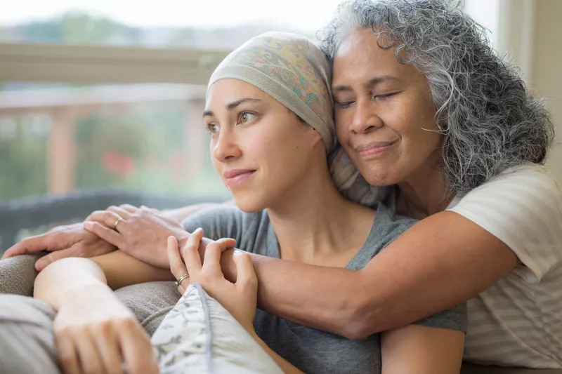 A senior mother hugging her mature daughter