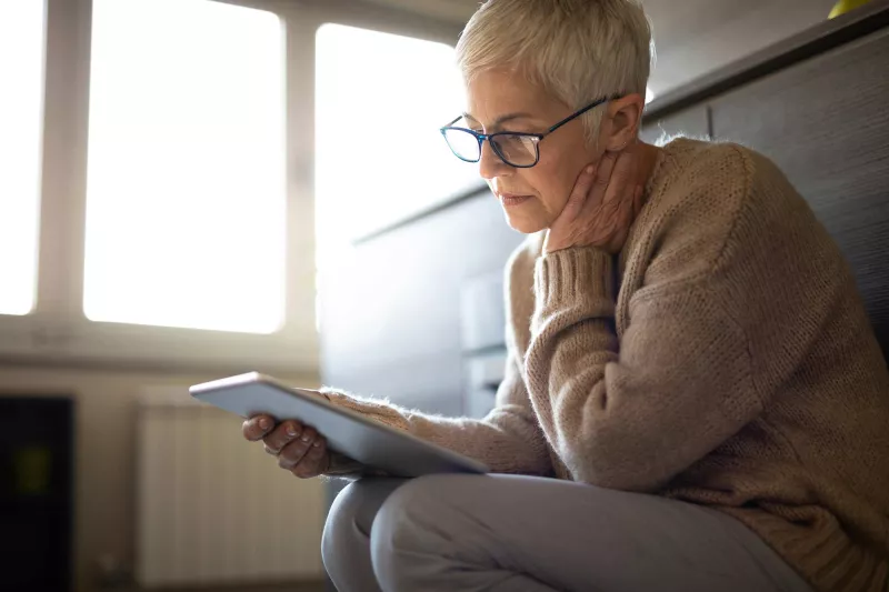 A senior woman on her tablet device