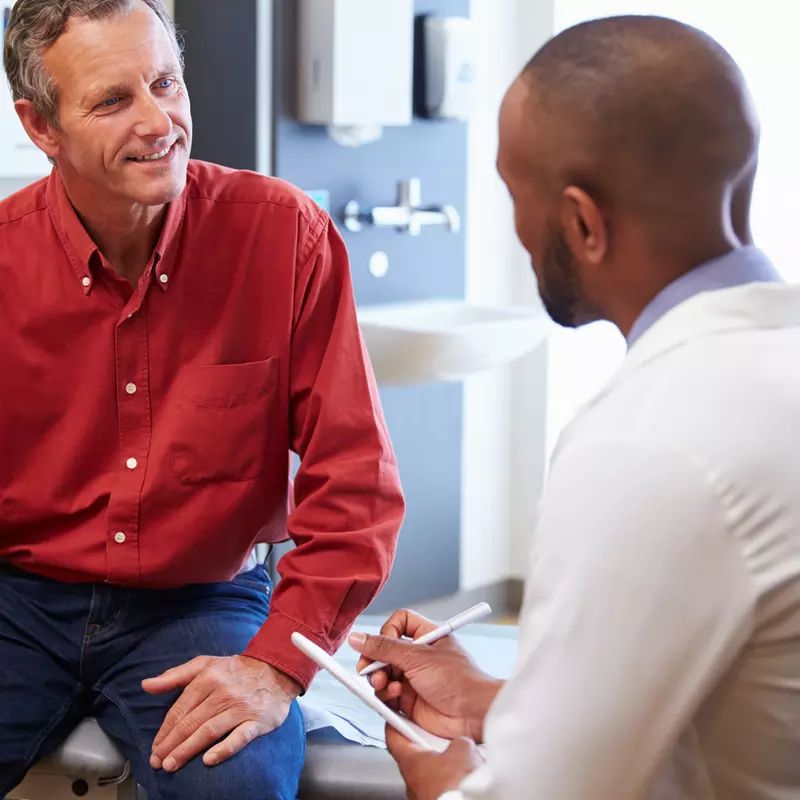 A man discusses his health with his doctor.