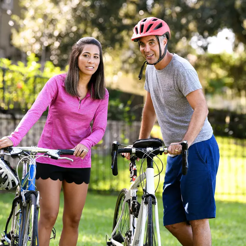 A Woman and Her Father Go For a Bicycle Ride in The Park on a Spring Day.