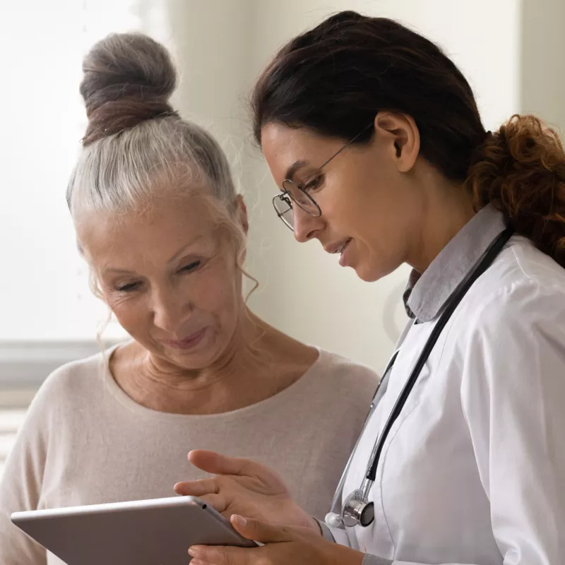 Doctor explaining to an older woman patient her test results.