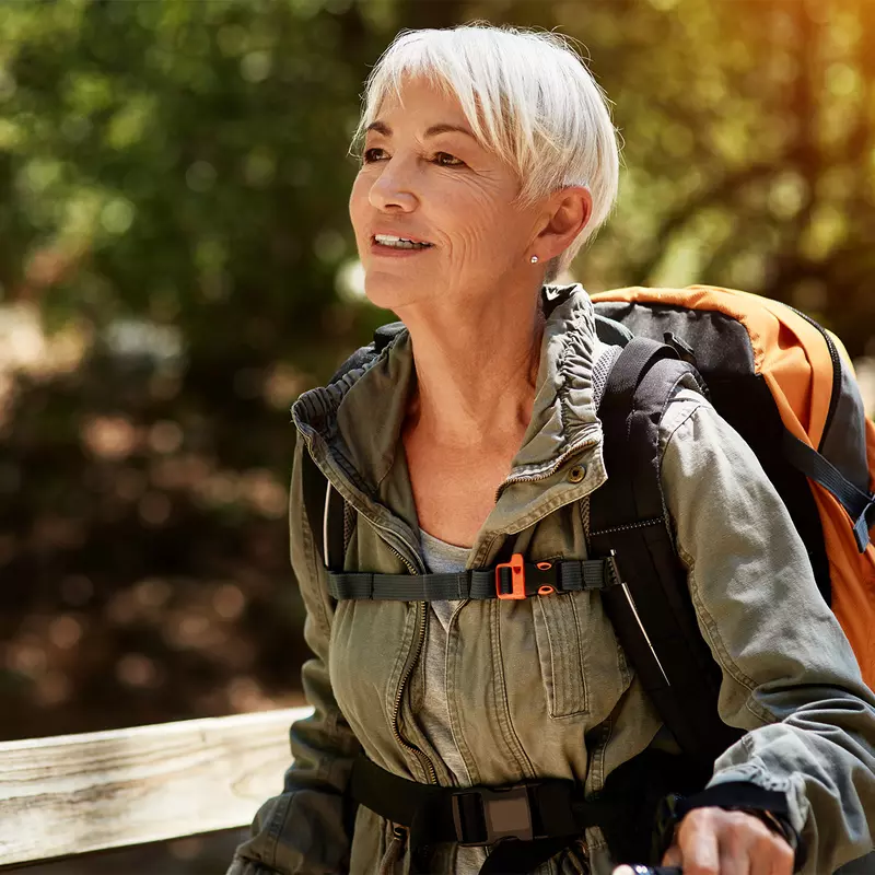 Older female backpacker out for a hike