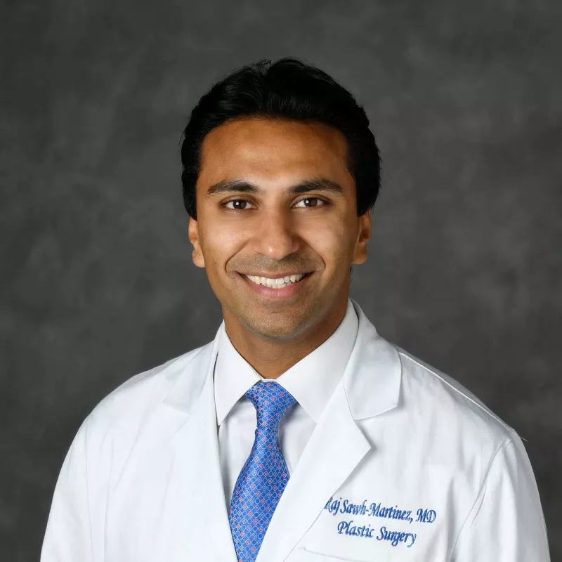 A professional headshot of Dr. Raj Martinez