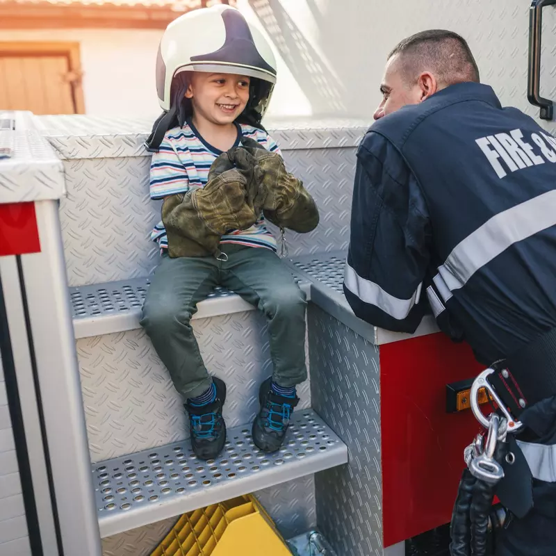 Smiling child with firefighter