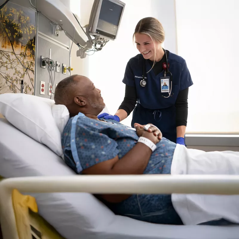 A Provider Speaks to a Patient in a Hospital Bed