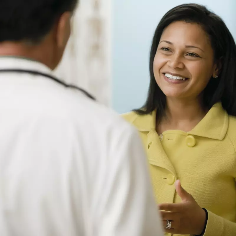 A woman talking to her doctor at a visit.