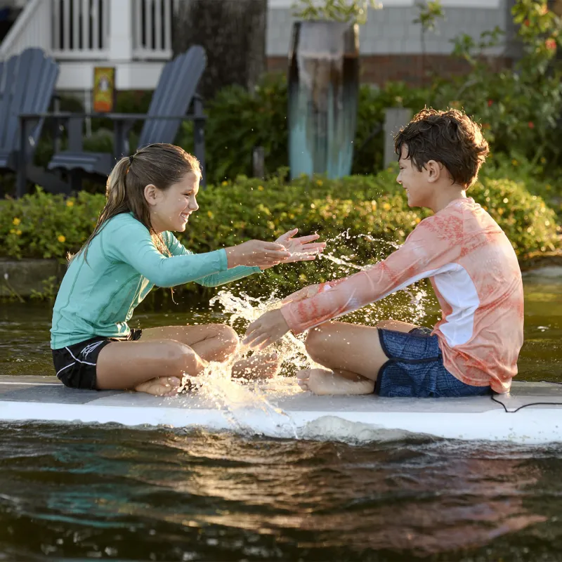Kids on a Paddleboard splashing water.