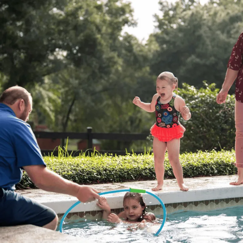 A family at the pool in summer.