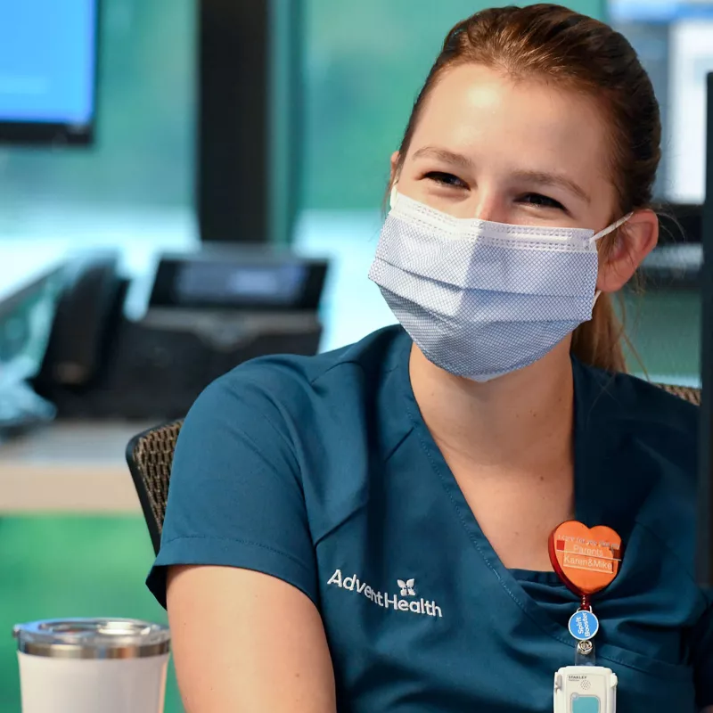 Physician in mask at computer