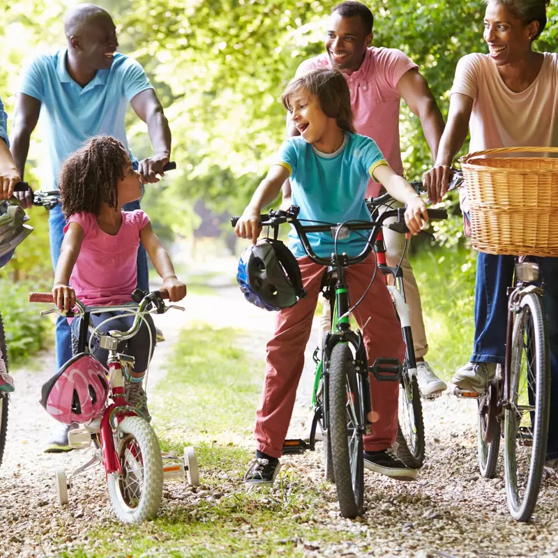 Multigenerational family riding bikes together.