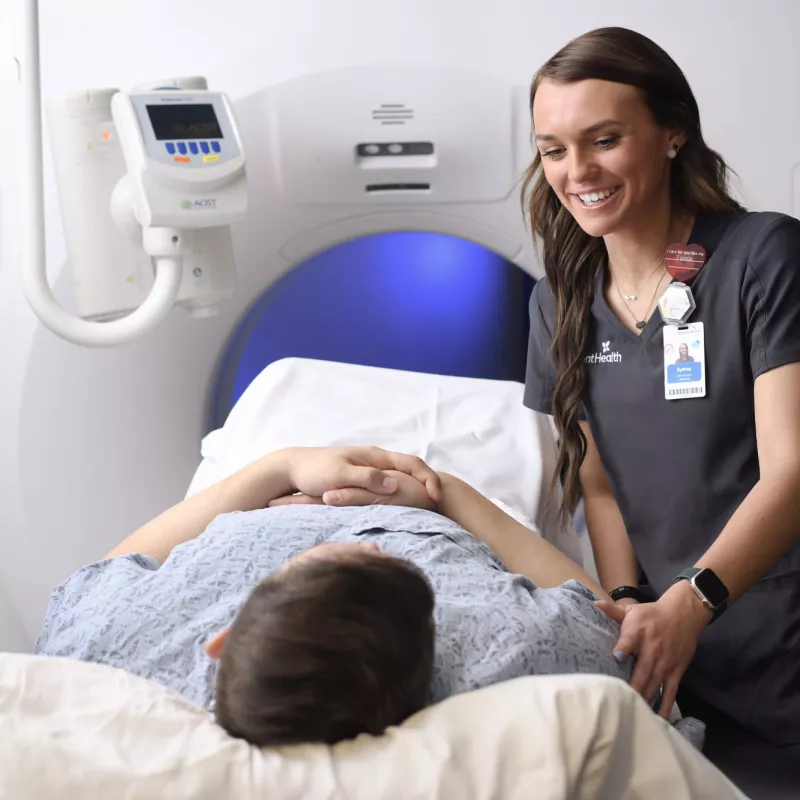 Radiologist reassures patient before imaging procedure.