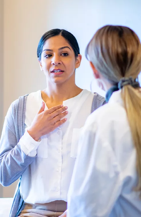 A young woman speaks to her female doctor.