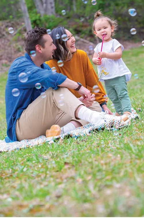 Family playing in yard together.