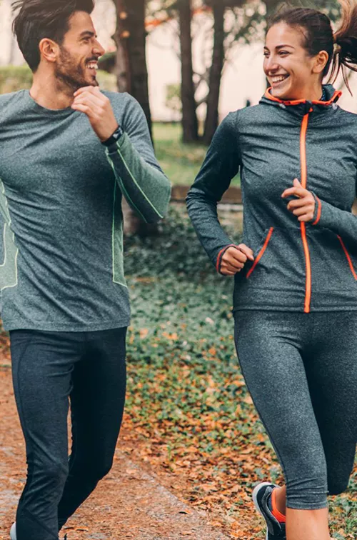 Two friends jogging in a park