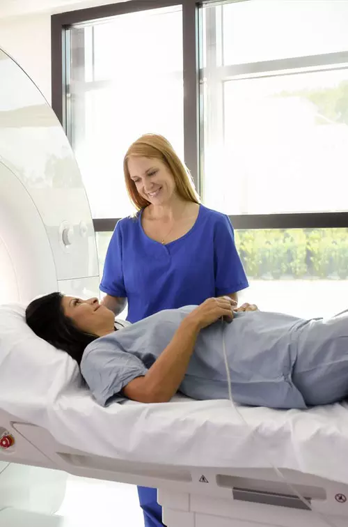 A woman prepares for an MRI.