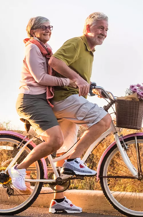 Older couple riding a bike together.