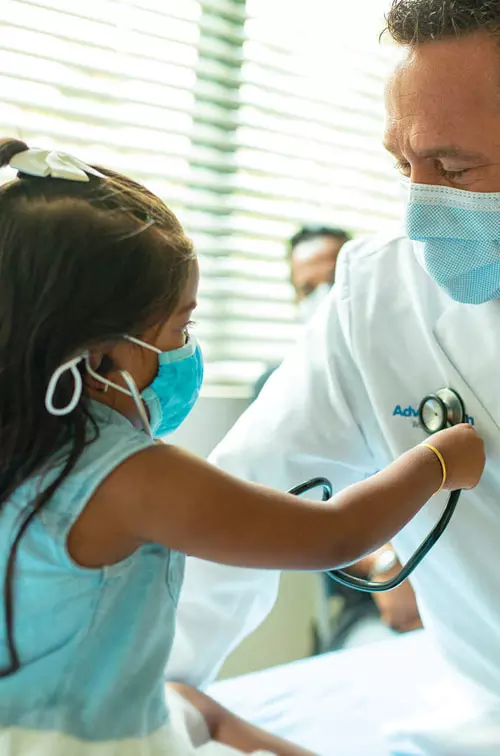 Doctor with pediatric patient in office 