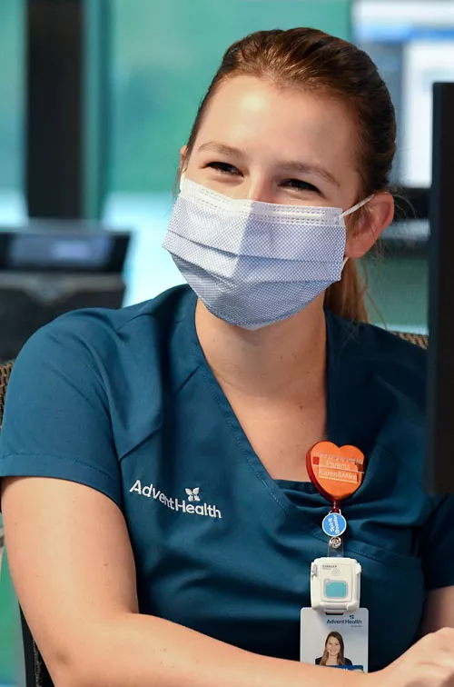 Physician in mask at computer